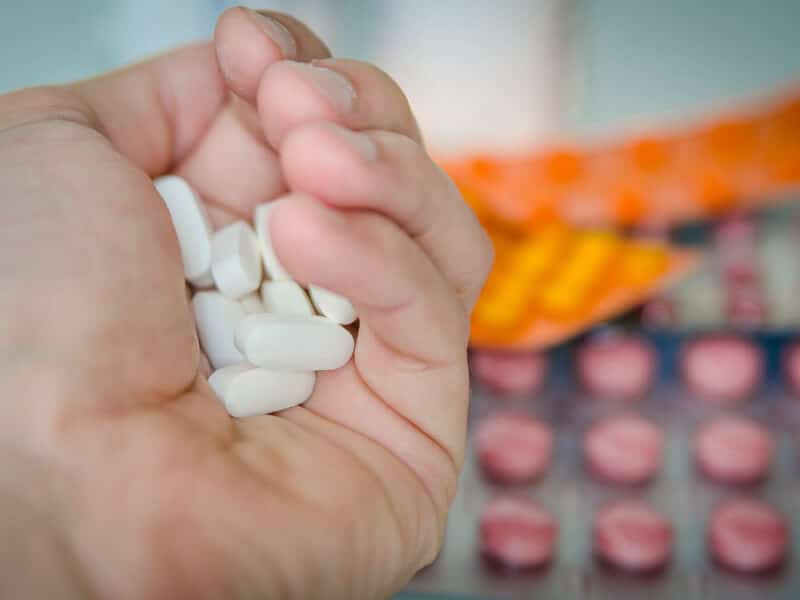 A hand full of pills.