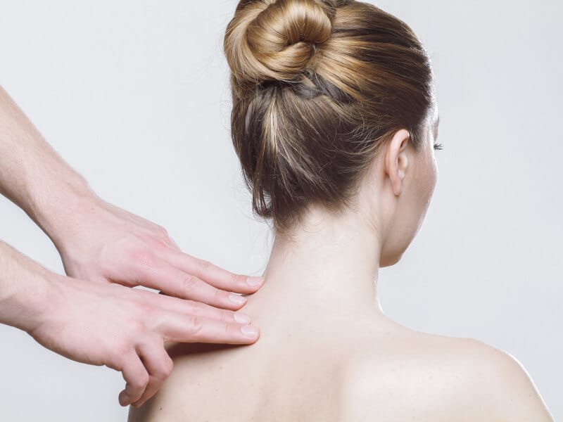 A woman's tense neck is being treated.