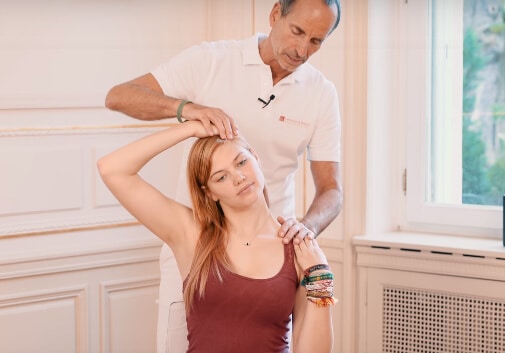 Roland assisting a girl with some neck stretches to relieve her tinnitus.
