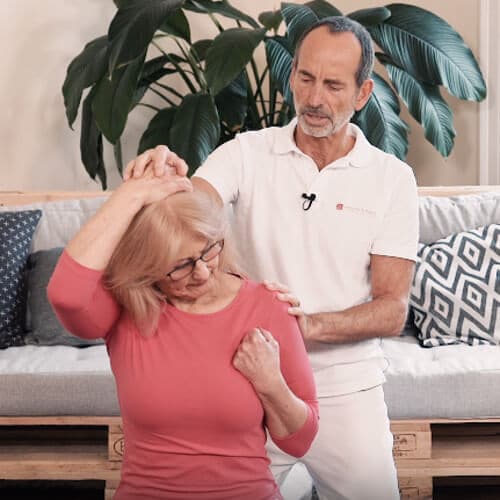 A woman is performing an atlas correction exercise.