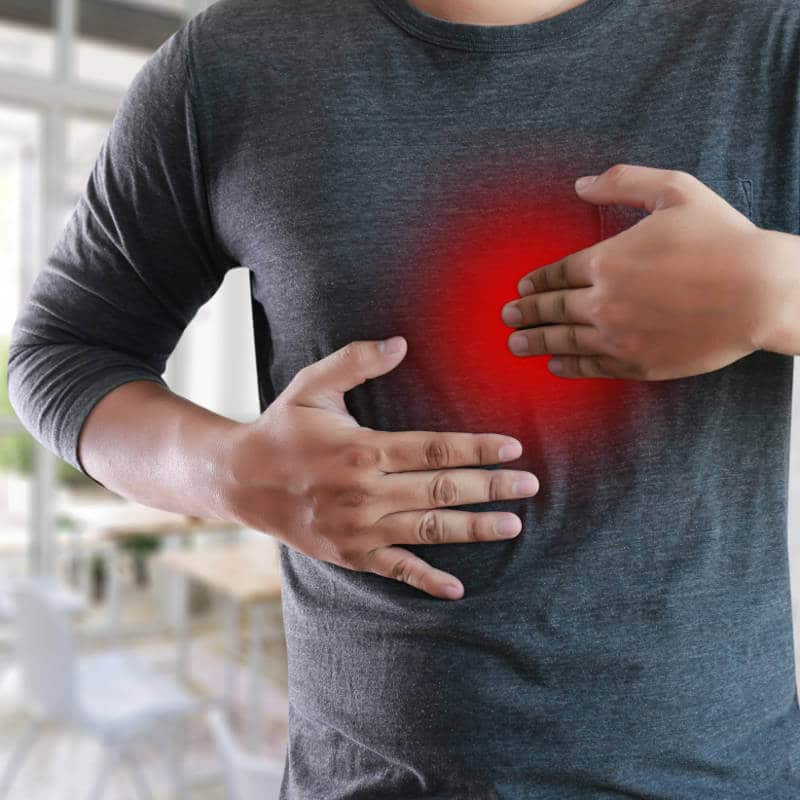 A man is pressing his chest.