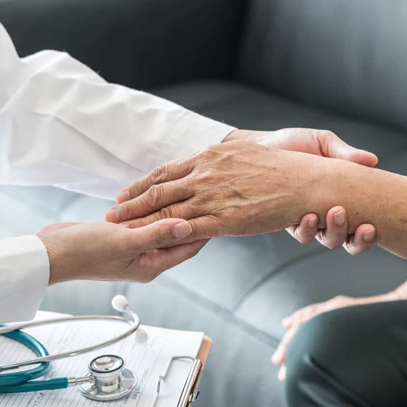 A GP examining the patient's wrist.