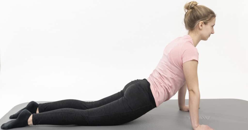 A woman is trying to bring her groin down to get rid of her back pain