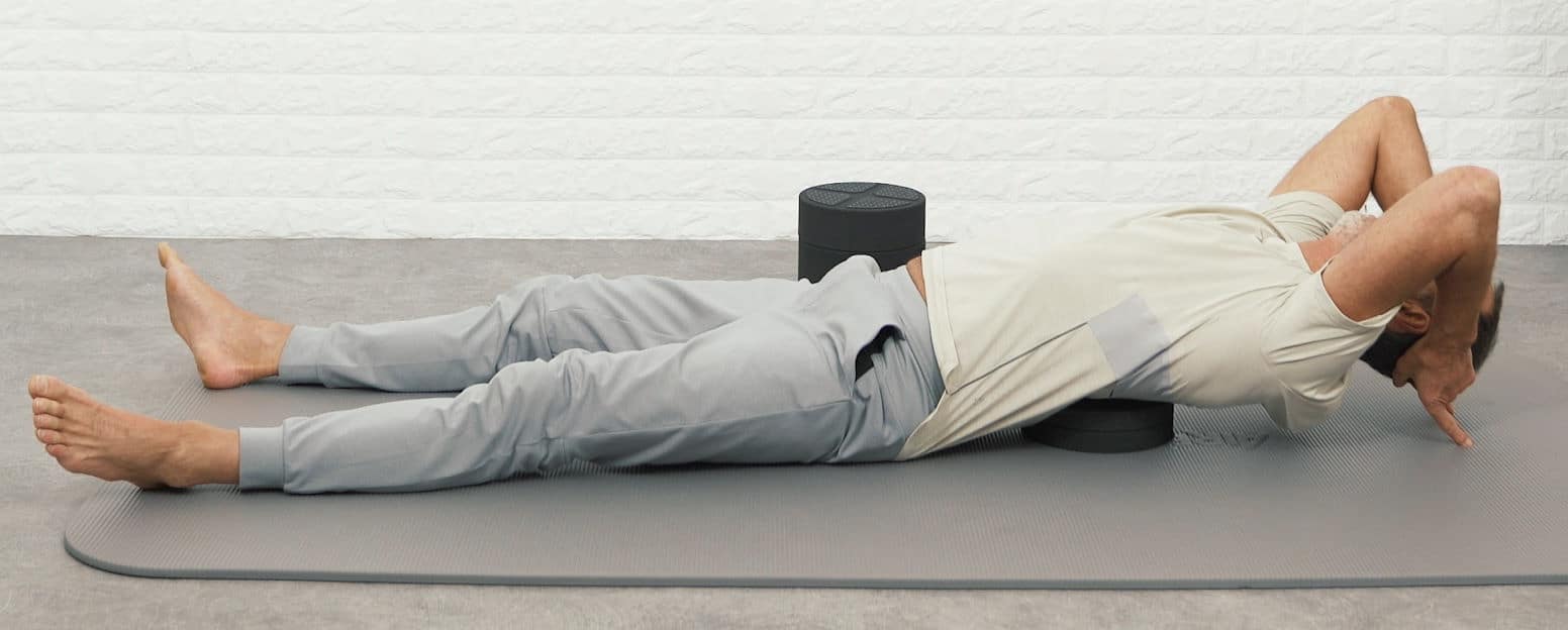 Roland is using the Back Hero to stretch his thoracic spine to relieve his back pain.