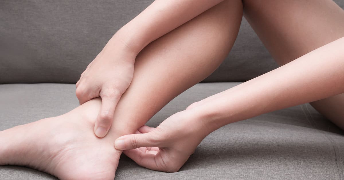 Closeup of someone pinching the back of their heel.