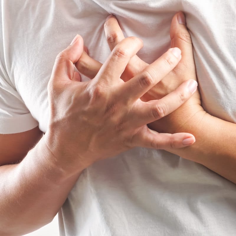 A man is clutching his chest in pain.